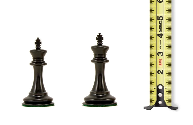 3.75 to 4 inch black chess king pieces with measuring tape for reference.