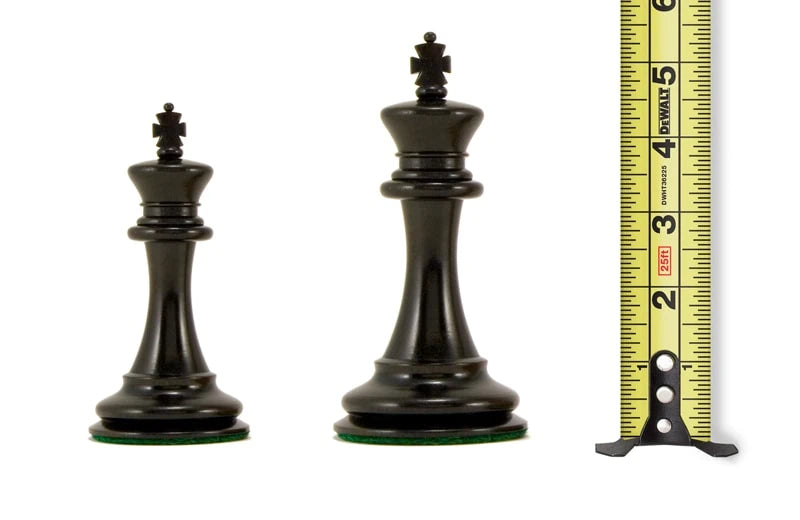 4+ inch black chess pieces next to a measuring tape showing varying heights