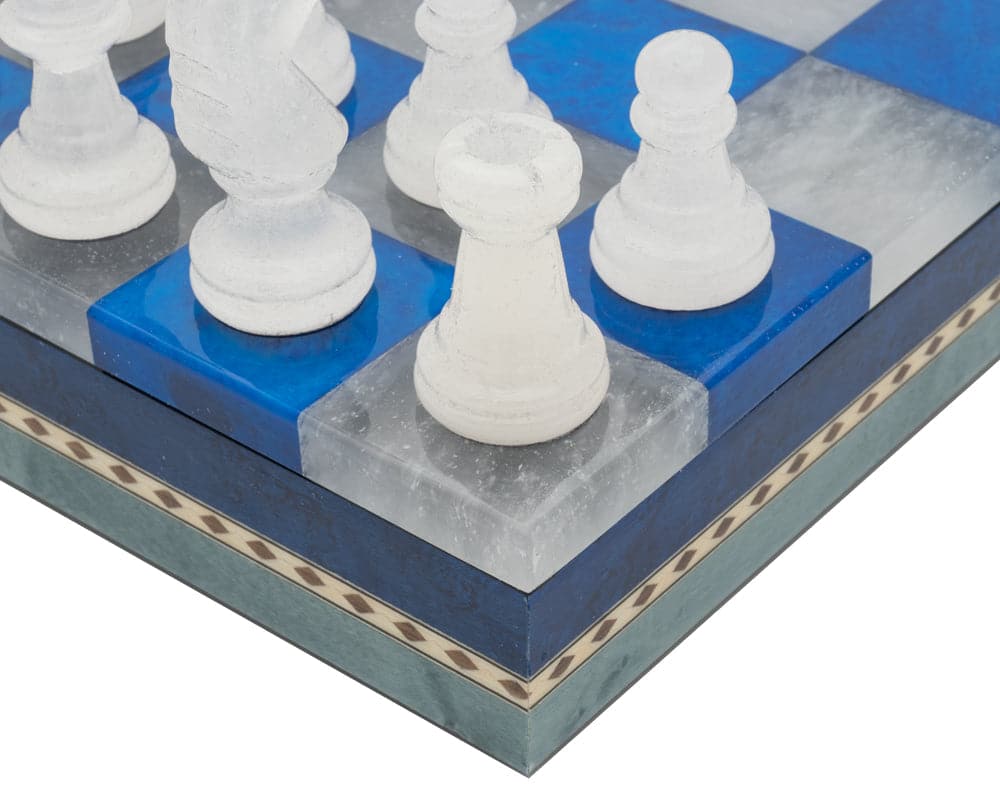 Close-up of Blue & White Alabaster Chess & Draughts Set on an Inlaid Wooden Cabinet Board.