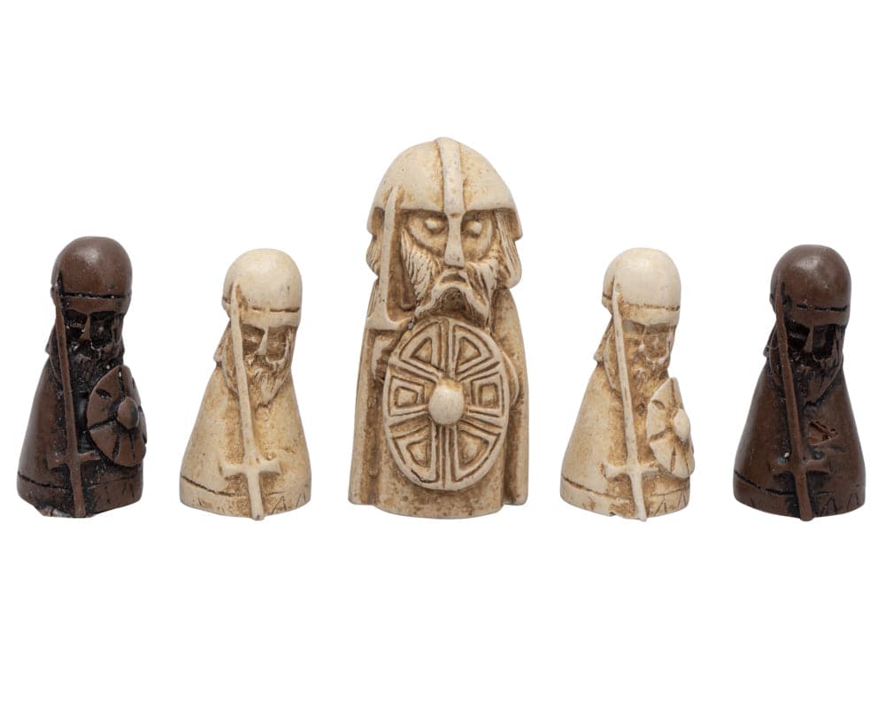 Lewis chessmen pieces including knights and a seated king on a white background