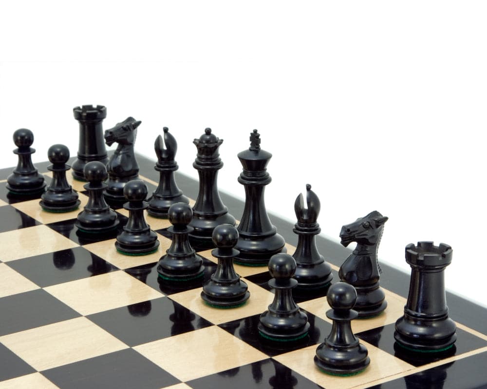 Windsor Series Ebony Staunton chess pieces set up on a chess board, featuring finely crafted and detailed 3-inch chessmen.