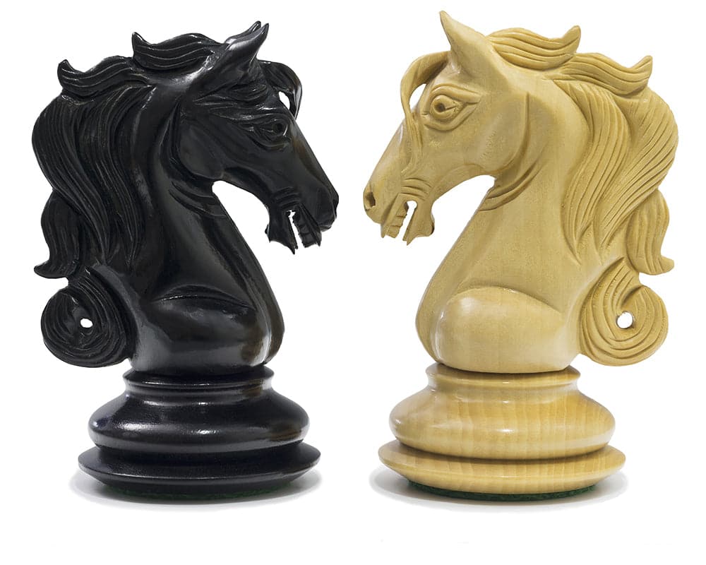 Intricately carved ebony and natural wood knight chess pieces from the Cavalry Series Chessmen set