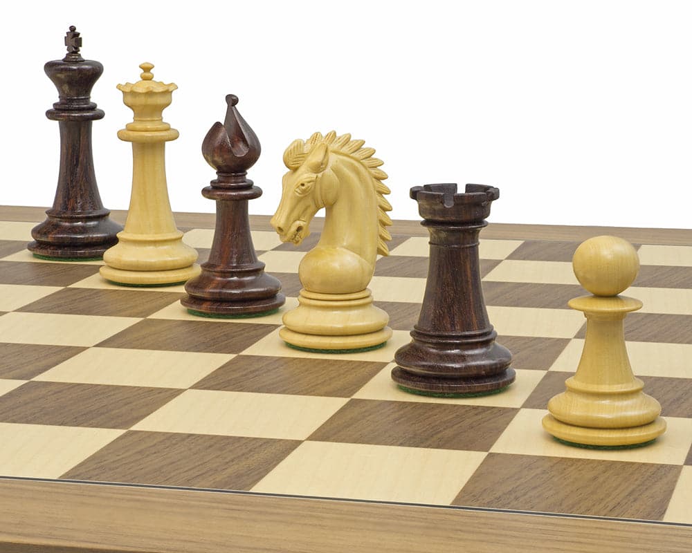 The Sheffield Knight Rosewood Chessmen set on a chessboard, featuring a 3.75 inch King and ornately detailed knight.