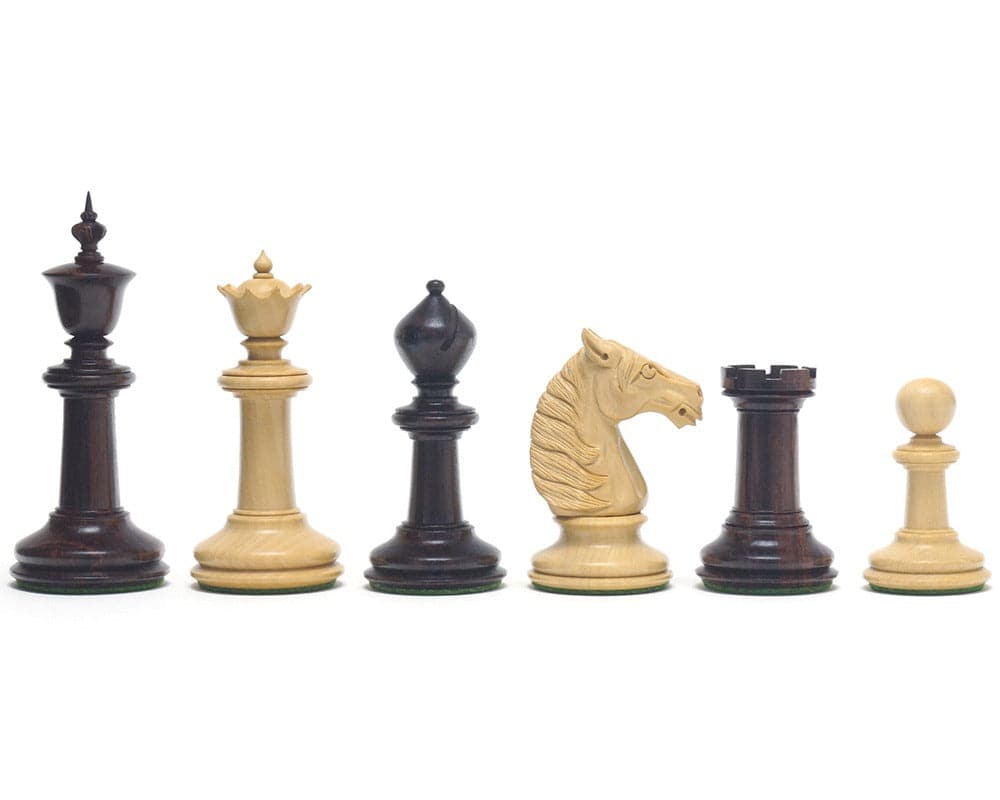 Hand-turned rosewood and ivory chessmen set with intricate carvings and weighted bases, featuring a 3.75 inch king and detailed knight.