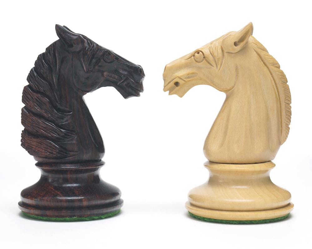 Hand turned Rosewood and Boxwood knight chess pieces from The Bath Chessmen 3.75 inch set, showcasing intricate carvings and detail.