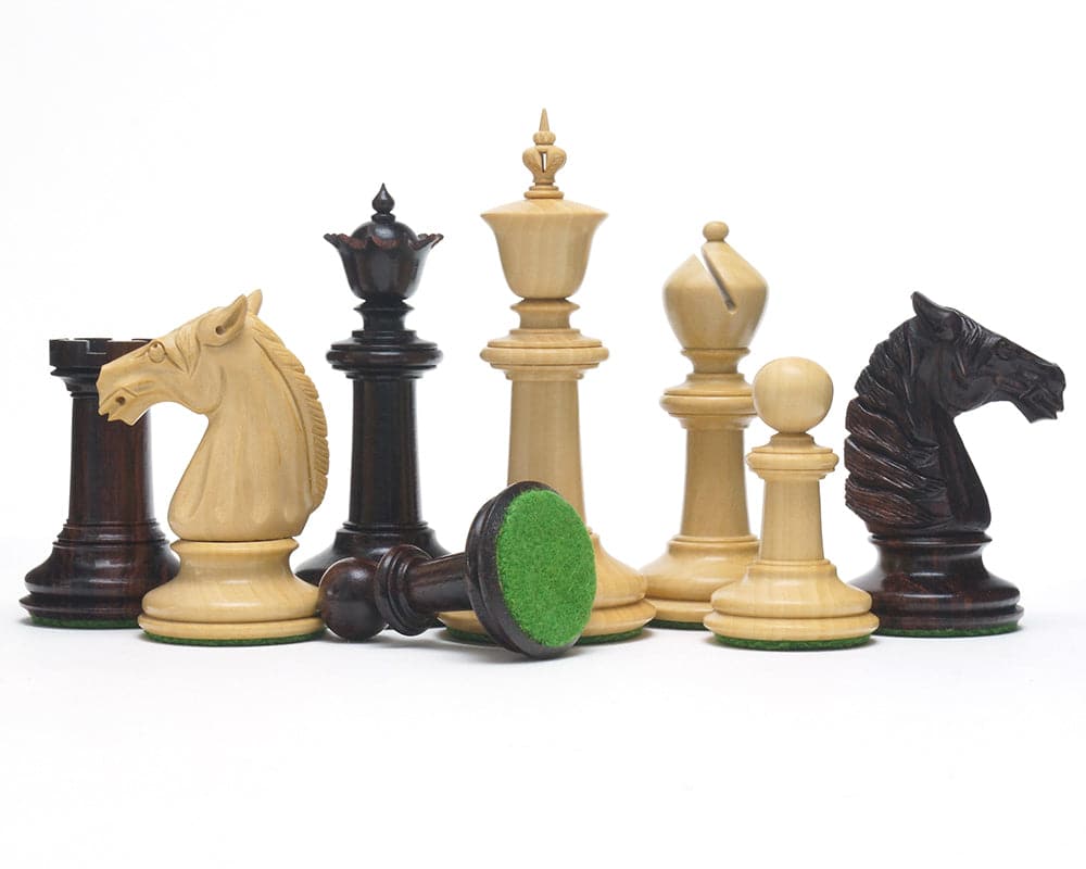 The Bath Chessmen 3.75 Inch Rosewood hand-turned chess pieces with intricate carvings and green billiard cloth bases.