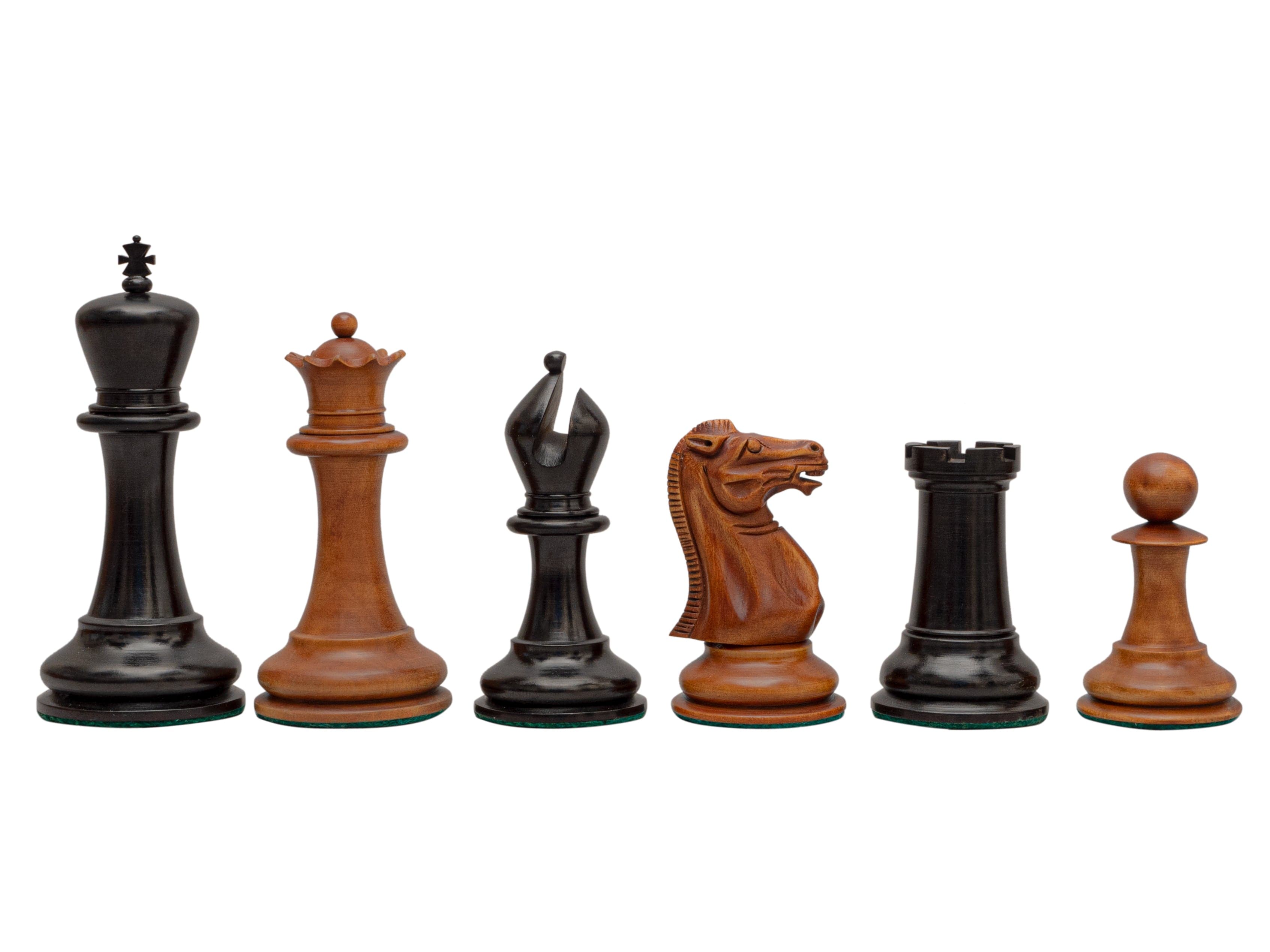 Reproduction Staunton Chessmen 1849 set with 4.4 inch king in antiqued boxwood and ebony pieces in a row.