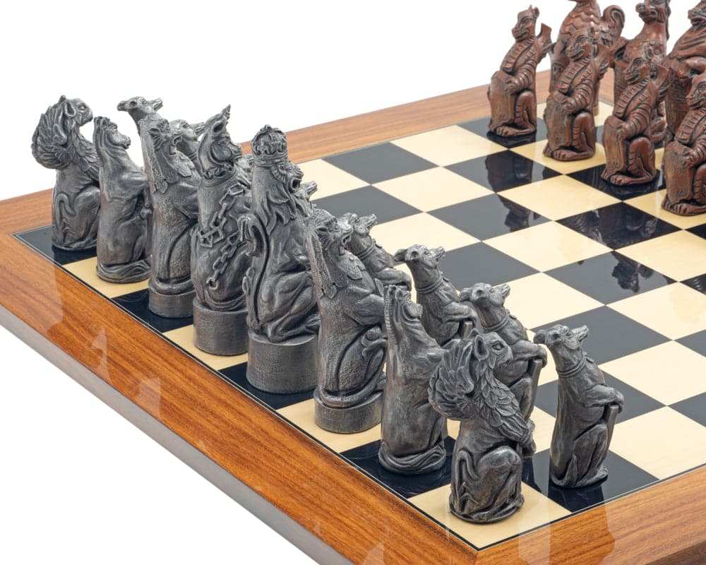 The Berkeley Chess Royal Beasts Metal and Palisander Grand Chess Set pieces on a wooden chessboard