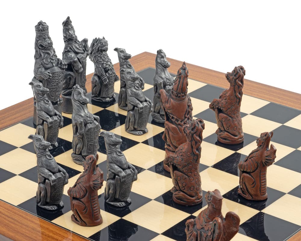 The Berkeley Chess Royal Beasts Metal and Palisander Grand Chess Set on a wooden chessboard.