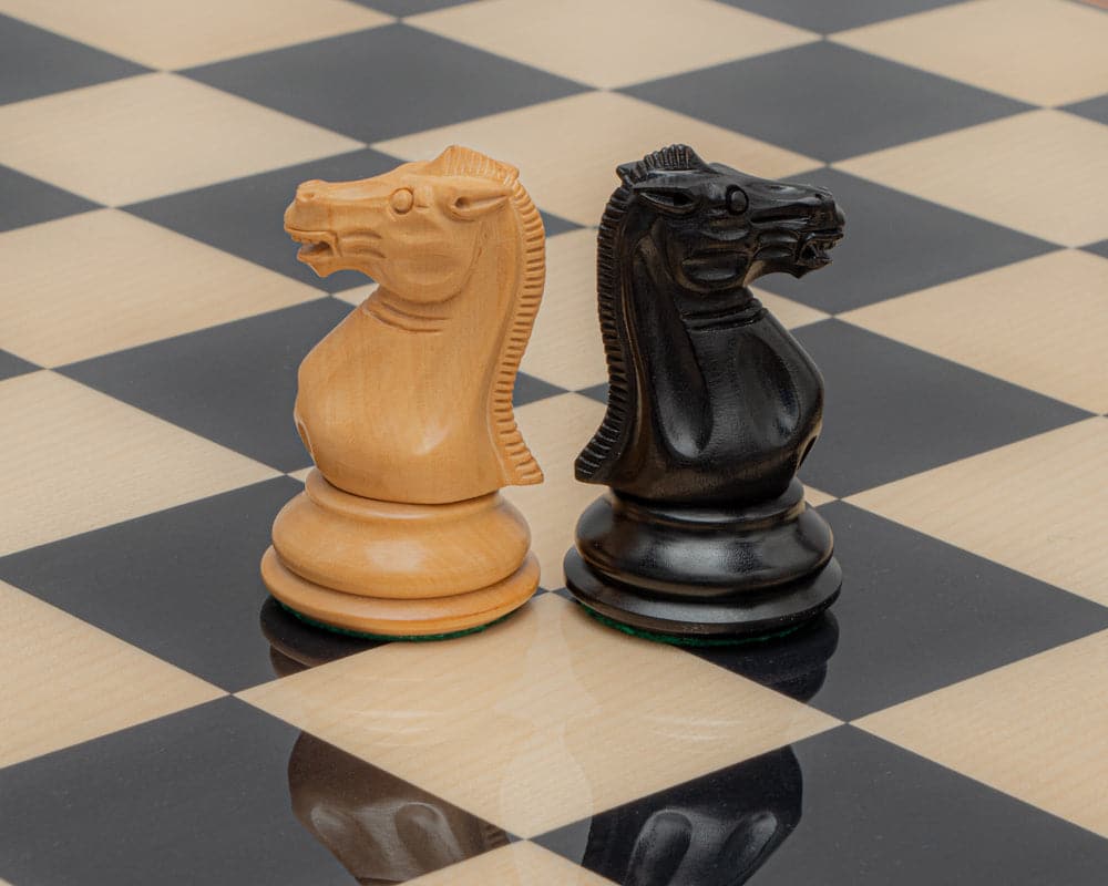 Natural and ebonised boxwood knight pieces on a chessboard from the 1849 Reproduction Staunton Ebony and Palisander Luxury Chess Set.