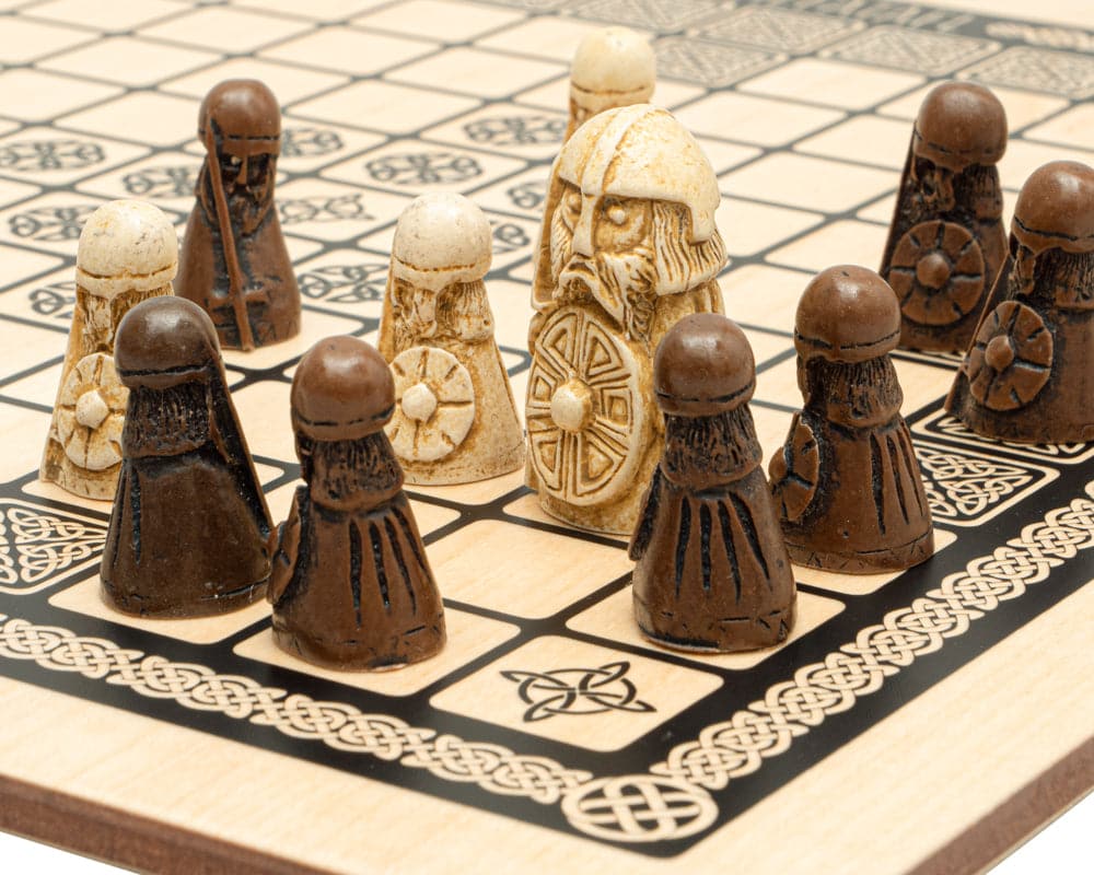 Viking chess pieces on inlaid Hnefatafl board with detailed decorations.