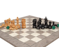 The Atlantic Black and Ash Burl Chess Set with polished, weighted, and felted boxwood pieces on a grey ash burl and maple board.