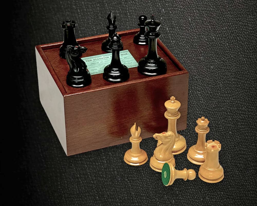 The 1850 London Limited Edition Ebony and Mahogany Chess Set with Case and Clock exemplary chess pieces displayed on wooden case