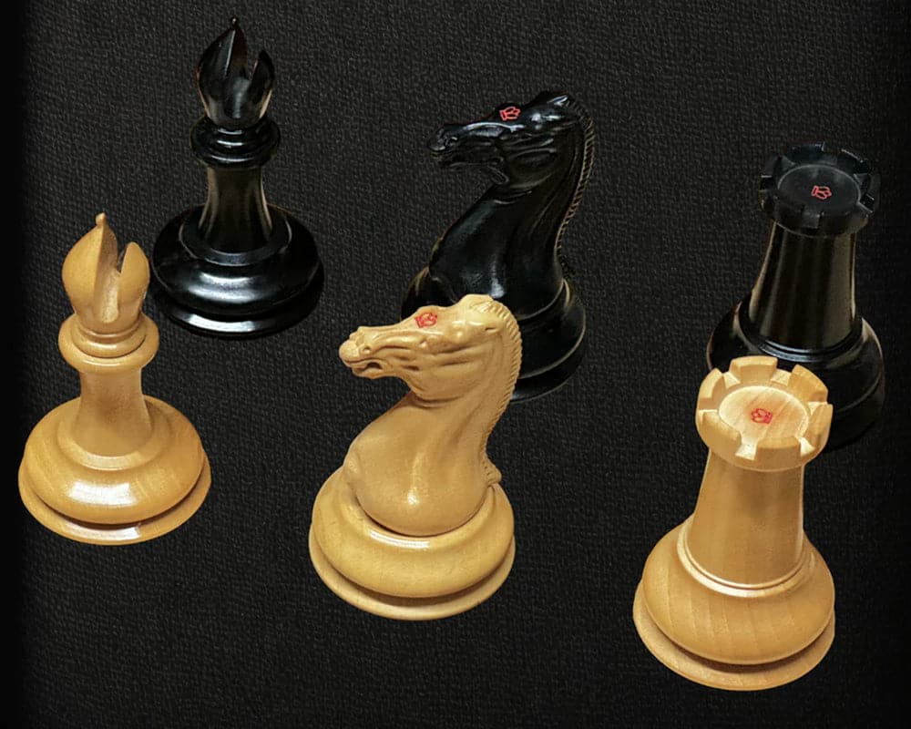 Luxury ebony and mahogany chess pieces from the 1850 London Limited Edition Chess set on a black background