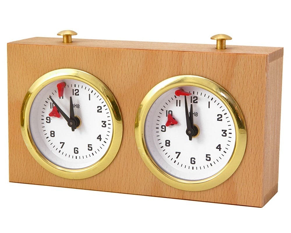 Wooden chess clock with dual round dials and brass accents highlighting timekeeping for chess games.